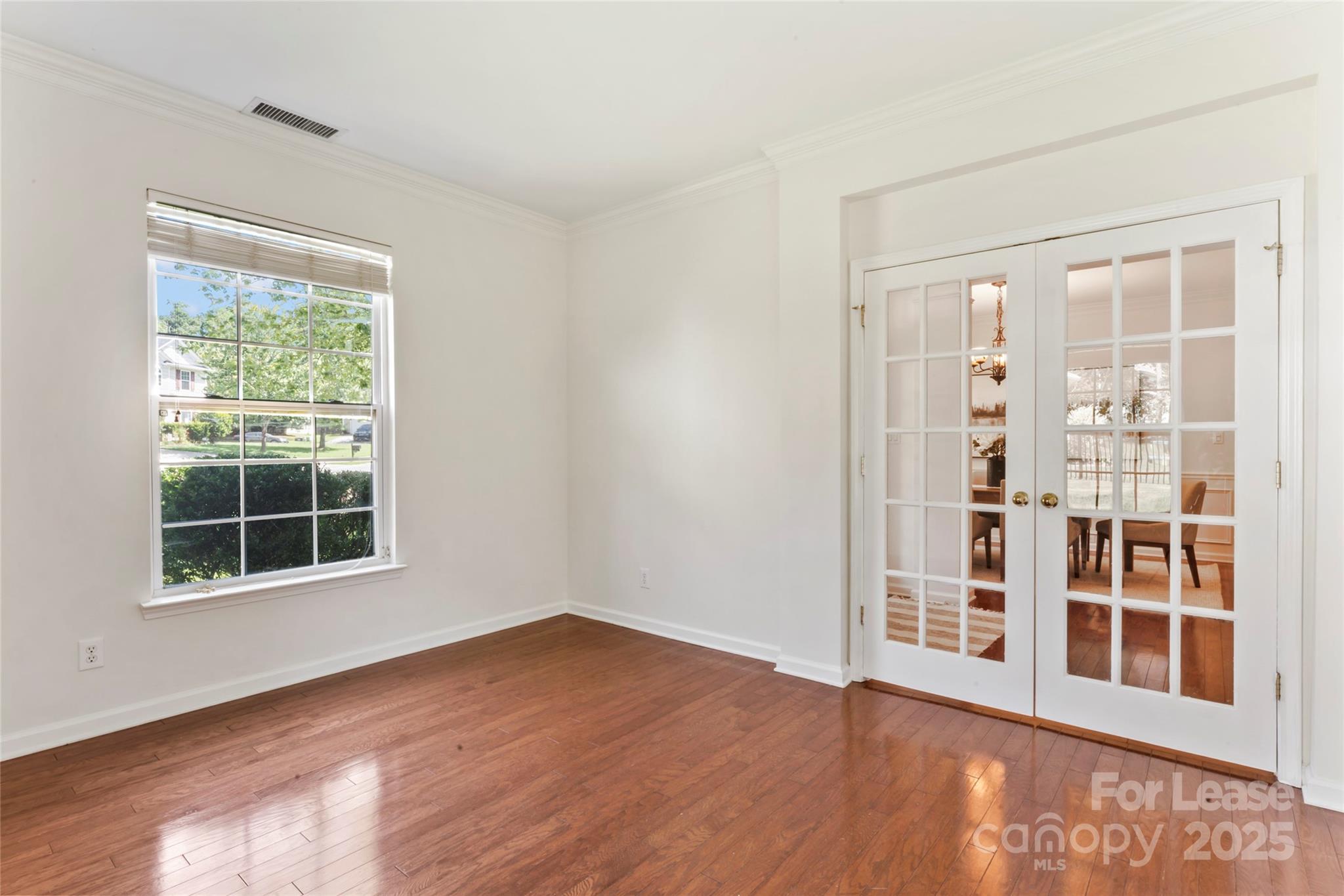 2003 Red Carpet Court Indian Trail, NC 28079 - Photo 15 of 28 an empty room with wooden floor and windows