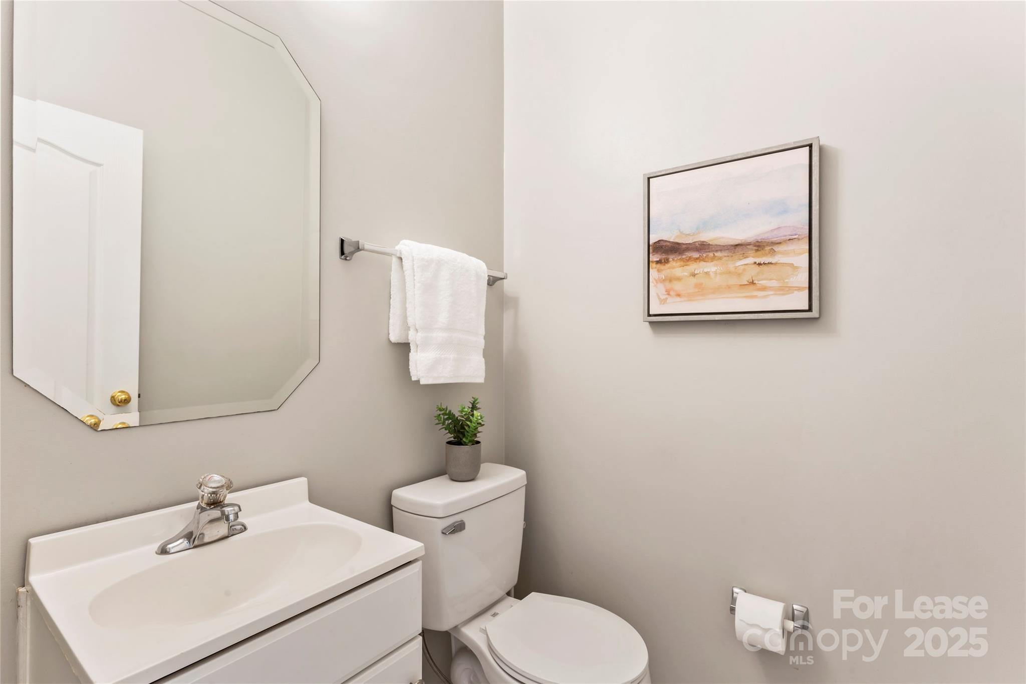 2003 Red Carpet Court Indian Trail, NC 28079 - Photo 20 of 28 a bathroom with a toilet sink and mirror