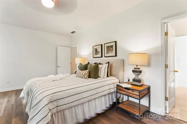 a bedroom with a bed and a lamp on table