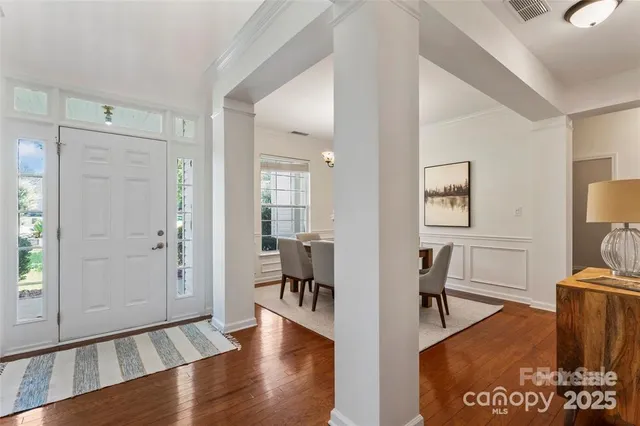 a view of a livingroom with furniture and hardwood floor