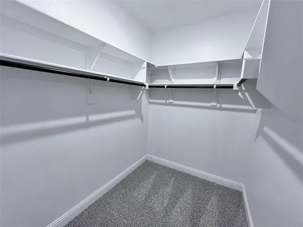 a bathroom with a tub sink vanity granite and mirror