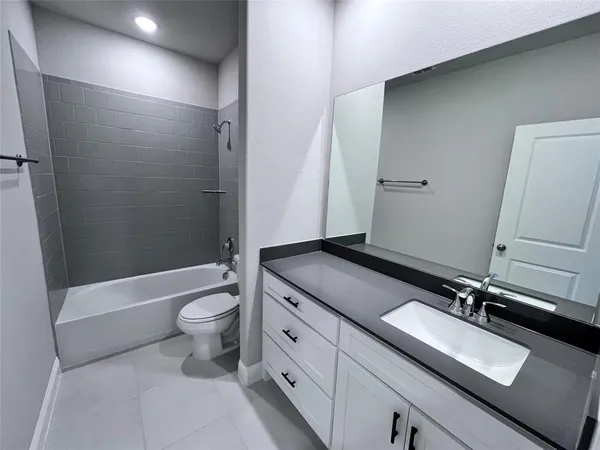 an empty room with windows and sink