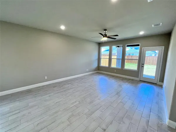 a large kitchen with stainless steel appliances granite countertop a large counter top a sink and a refrigerator