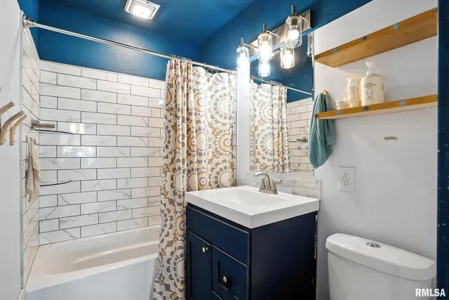 a bathroom with a sink mirror toilet and bathtub