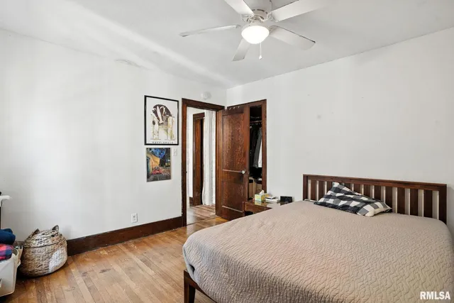 a bedroom with a large bed and a chandelier