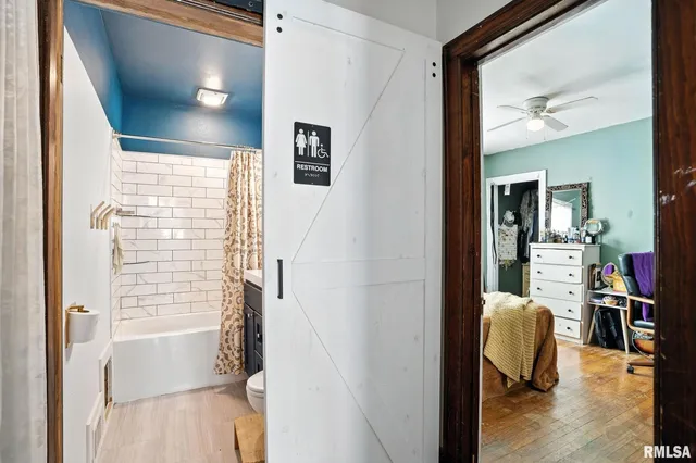 a view of a hallway with furniture and a window