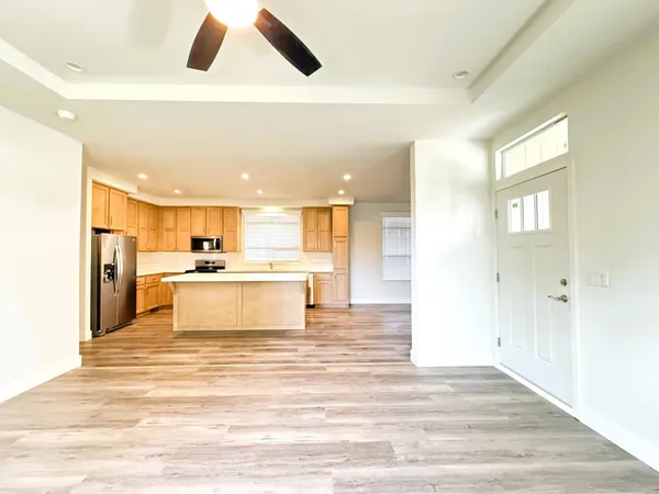 a view of kitchen with white cabinets and refrigerator