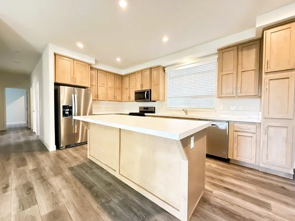 a kitchen with stainless steel appliances granite countertop a refrigerator sink and cabinets