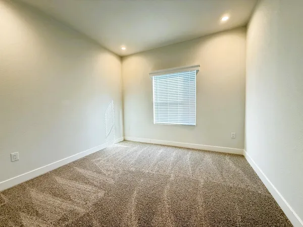 an empty room with a empty space and windows