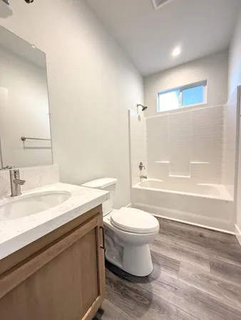 a bathroom with a sink a toilet and bathtub