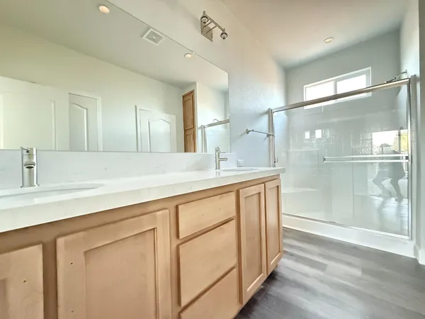 a bathroom with a double vanity sink and mirror
