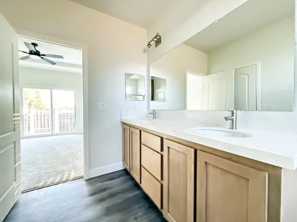 a bathroom with a double vanity sink and a mirror