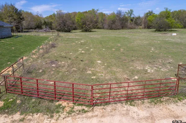a view of a yard with wooden fence