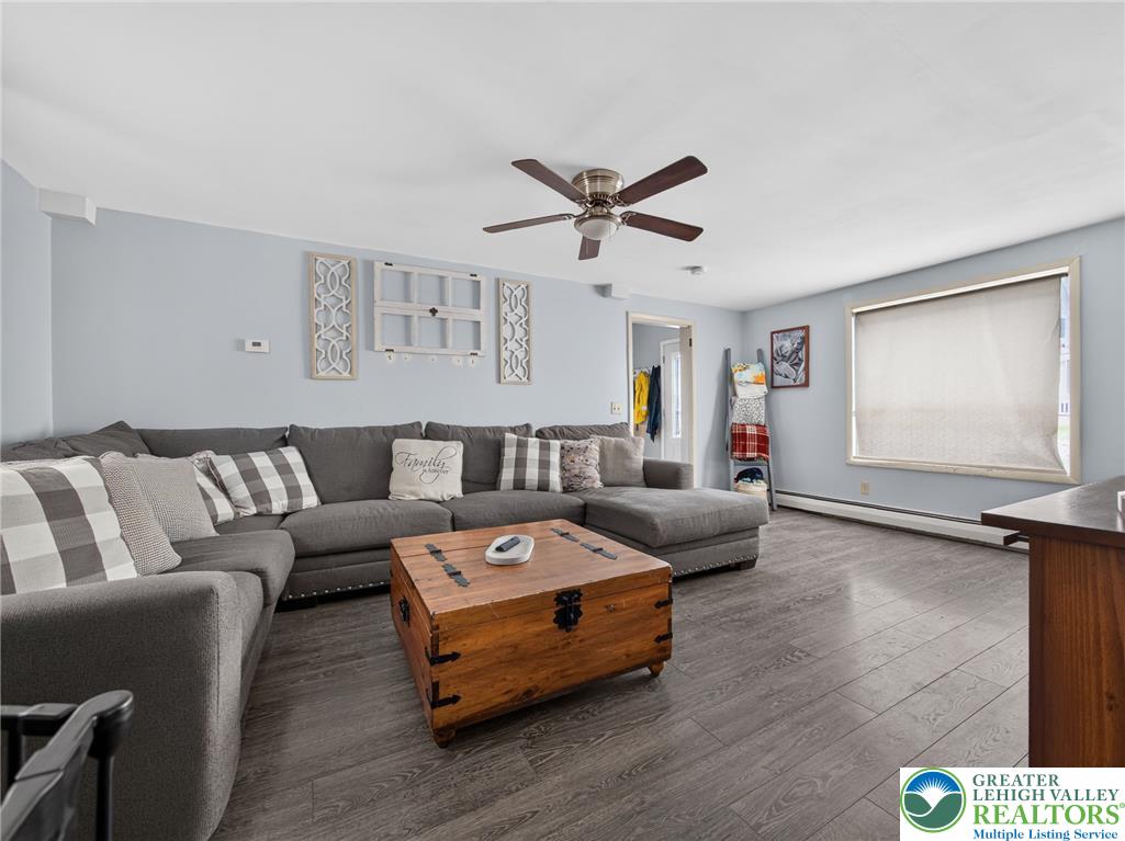 2628 Levans Road Coplay, PA 18037 - Photo 10 of 54 A comfortable living space boasts durable hardwood flooring and a functional ceiling fan for year-round comfort.