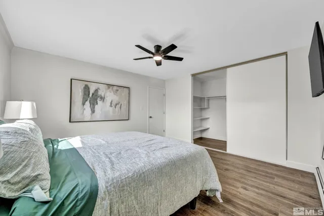 a bedroom with a bed and a ceiling fan