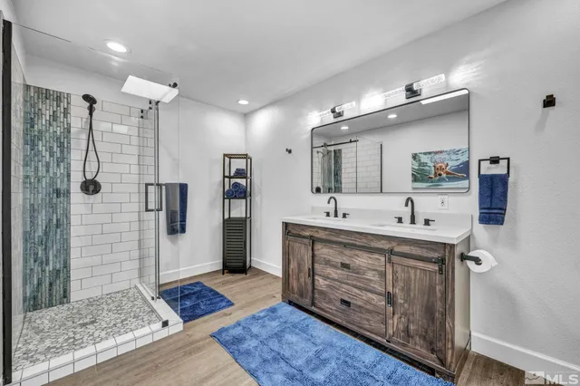 a spacious bathroom with a shower sink and mirror