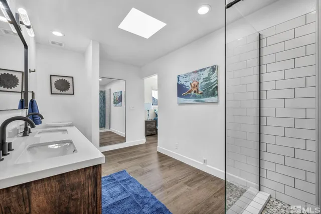 a en suite bathroom with a sink and a large mirror