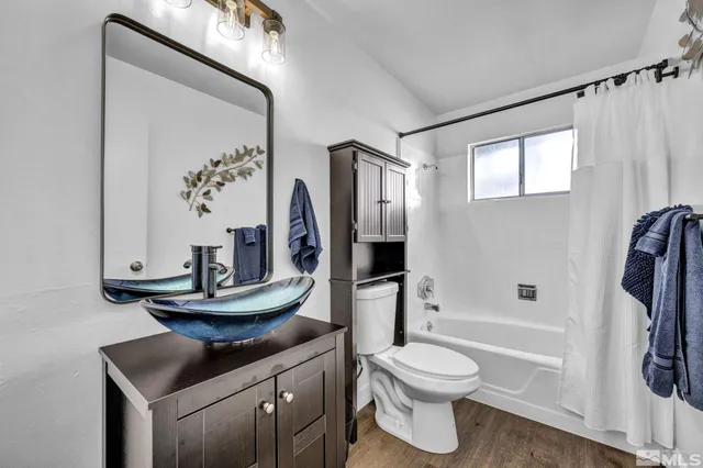 a bathroom with a toilet a sink and a mirror