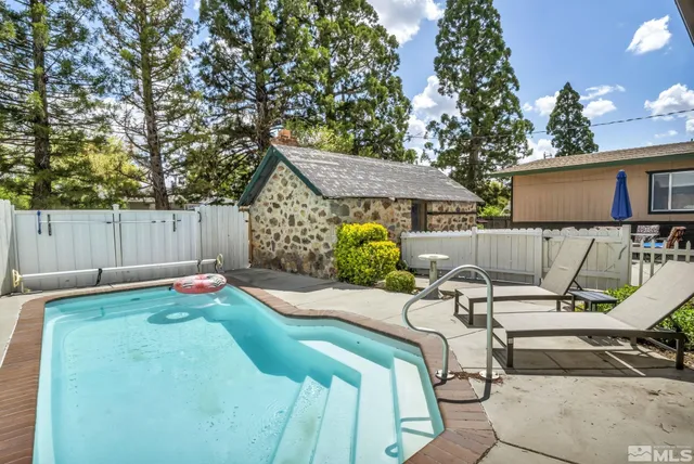 a view of backyard of house with seating space