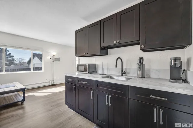 a kitchen with sink and cabinets
