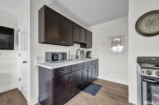 a kitchen with stainless steel appliances a stove a sink a stove and a refrigerator