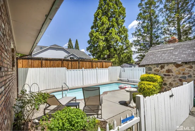 a view of a patio with table and chairs and potted plants