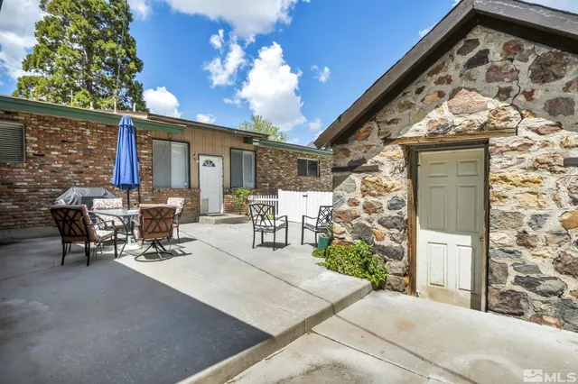 a view of a patio with table and chairs and potted plants