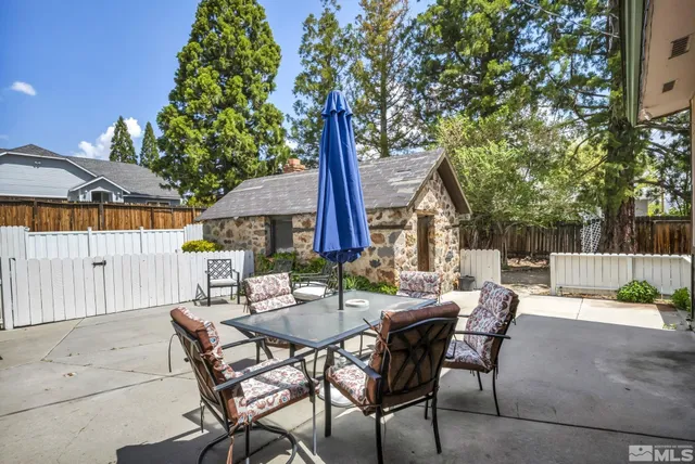 a view of backyard with outdoor seating a patio and plants