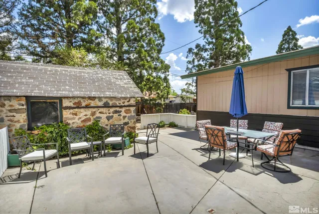 a building outdoor space with patio furniture and potted plants