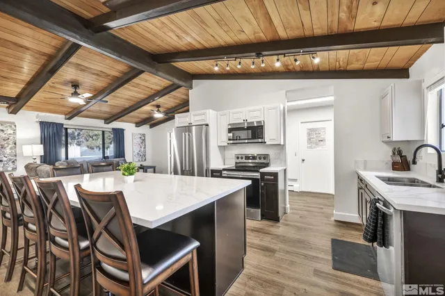 a kitchen with stainless steel appliances granite countertop a stove a sink dishwasher and a refrigerator