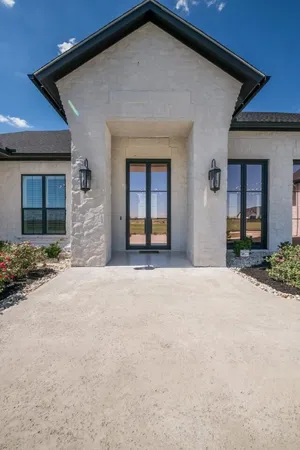 a kitchen with stainless steel appliances granite countertop a sink a stove and a wooden floors