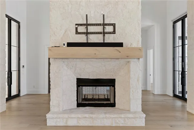 a view of empty room with a fireplace