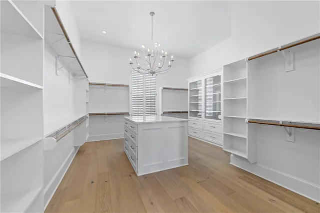 a view of a pool a dinning table and chairs with wooden floor