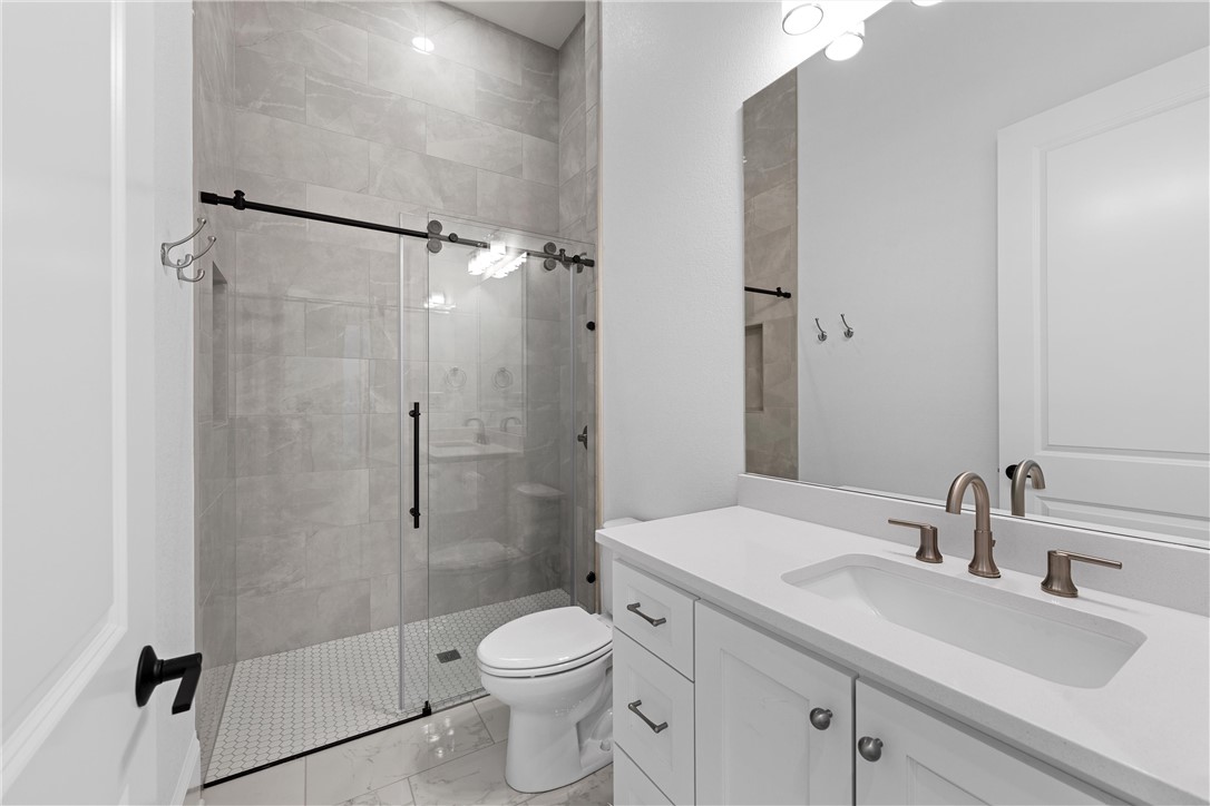 134 Sunflower Street Lorena, TX 76655 - Photo 58 of 86 a bathroom with a sink a toilet and shower