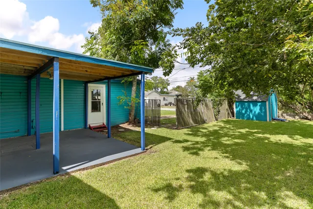 a backyard of a house with table and chairs