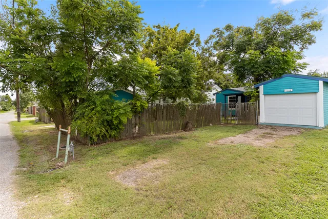 a backyard of a house with table and chairs
