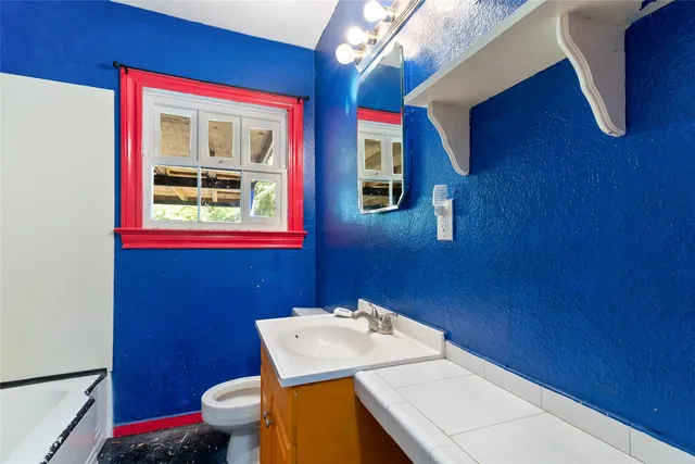 a bathroom with a toilet and a sink