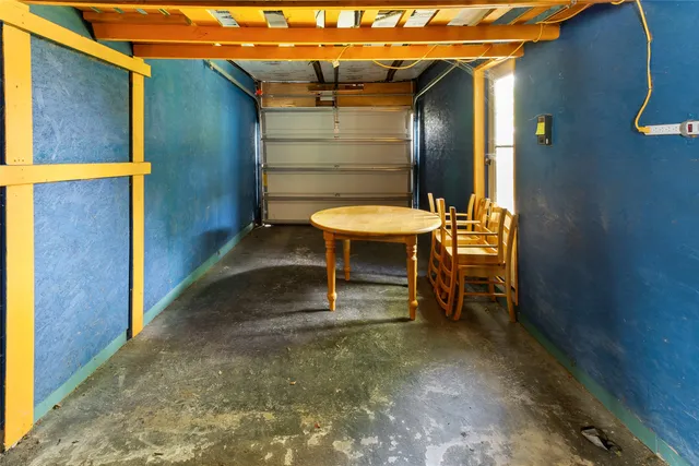 a backyard of a house with table and chairs