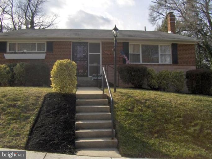 12910 Bluhill Road Silver Spring, MD 20906 - Photo 1 of 10 a view of a house with backyard and trees