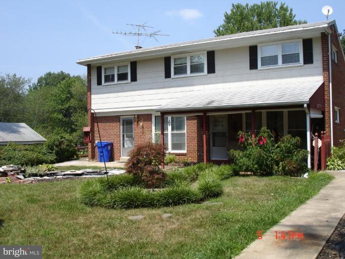 12910 Bluhill Road Silver Spring, MD 20906 - Photo 10 of 10 a front view of a house with a yard and potted plants