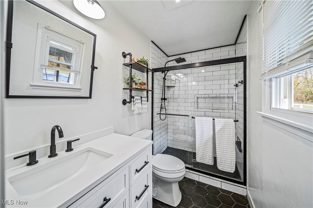 4188 State Road South Ashtabula, OH 44004 - Photo 19 of 46 Bathroom featuring toilet, walk in shower, vanity, and tile patterned floors