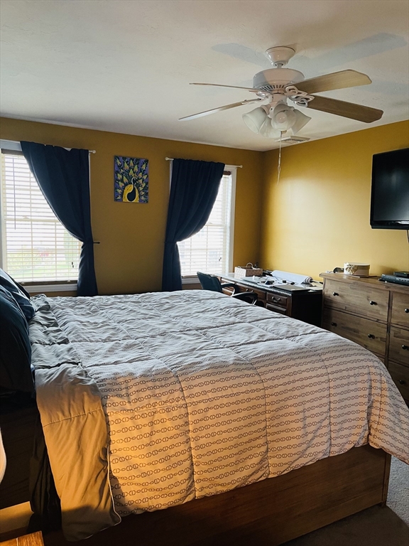 515 Kennedy Street Fall River, MA 02721 - Photo 21 of 34 a bedroom with a bed and a chandelier