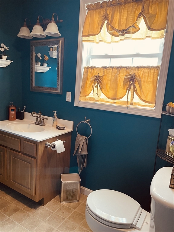 515 Kennedy Street Fall River, MA 02721 - Photo 8 of 34 a bathroom with a sink a mirror and a toilet