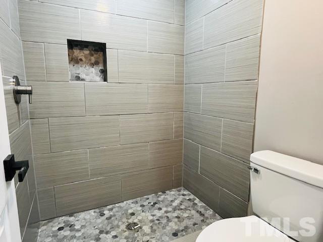 8781 Mill Branch Road Rocky Mount, NC 27803 - Photo 12 of 19 a bathroom with a toilet and a shower