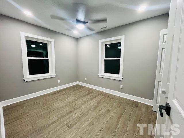 8781 Mill Branch Road Rocky Mount, NC 27803 - Photo 16 of 19 a view of an empty room with wooden floor and a window