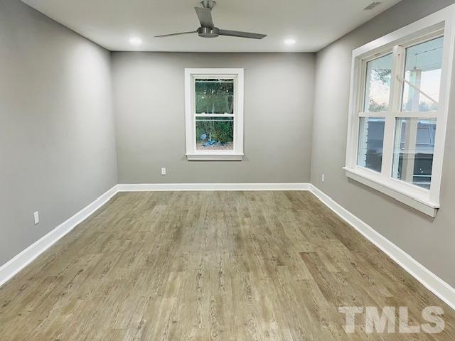 8781 Mill Branch Road Rocky Mount, NC 27803 - Photo 17 of 19 an empty room with wooden floor and windows