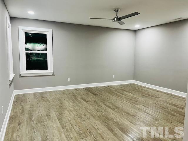 8781 Mill Branch Road Rocky Mount, NC 27803 - Photo 9 of 19 a view of an empty room with a window and wooden floor