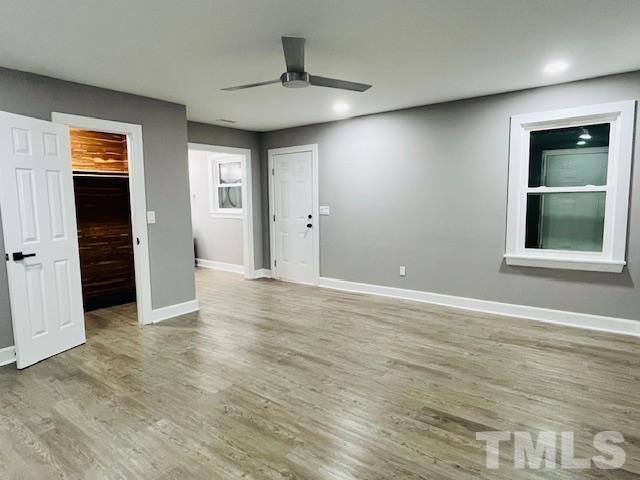 8781 Mill Branch Road Rocky Mount, NC 27803 - Photo 10 of 19 an empty room with wooden floor and windows