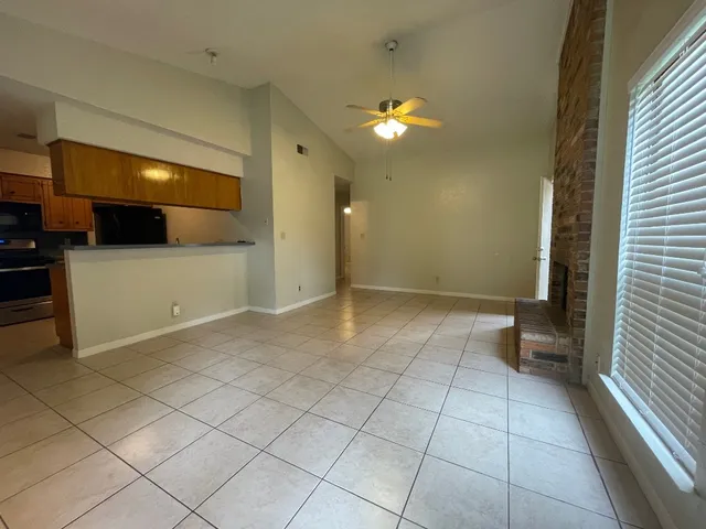a view of a livingroom with an empty space and a window