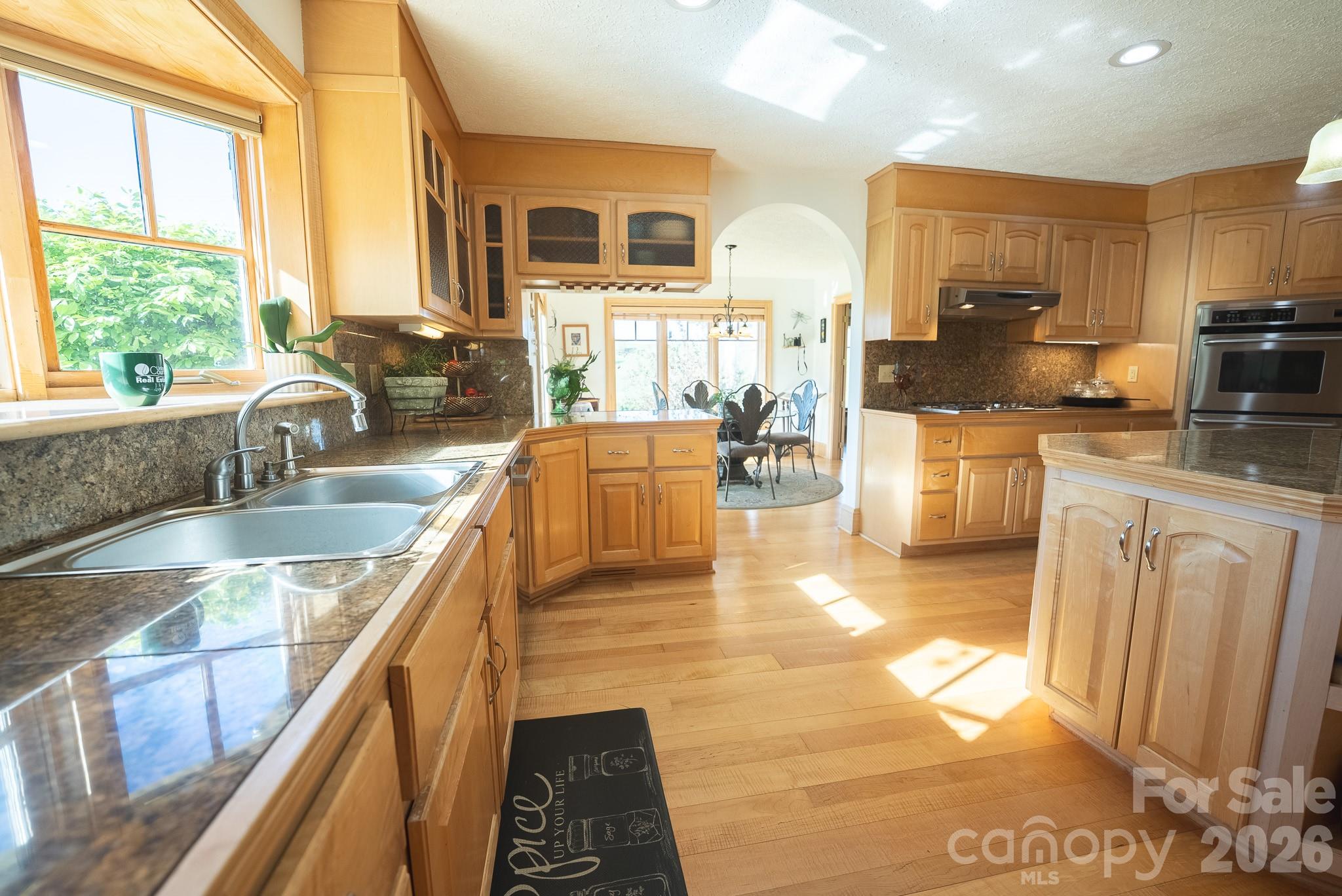 6985 Junaluska Road Boone, NC 28607 - Photo 21 of 35 a kitchen with stainless steel appliances granite countertop a sink stove and cabinets
